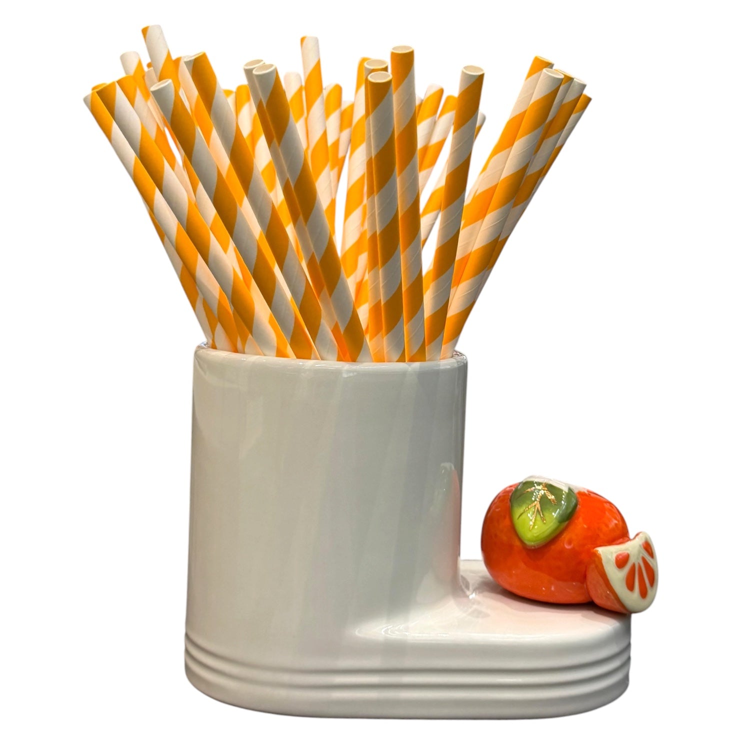 White holder with orange and white striped straws and a small decorative fruit on a white background