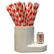 White holder with red and white striped straws and a Coca-Cola can on a white background