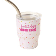 White tumbler with colorful polka dots and 'birthday cheers' text on a beige background